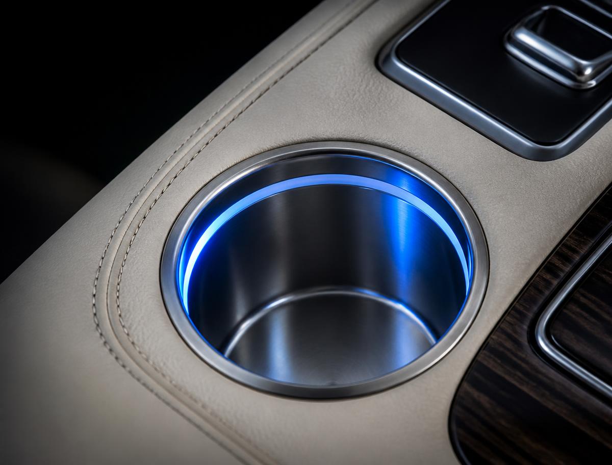 Illuminated cup holder with a blue LED ring in a leather console